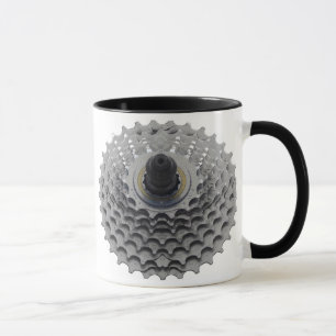 Taza de café con el piñón de la bici
