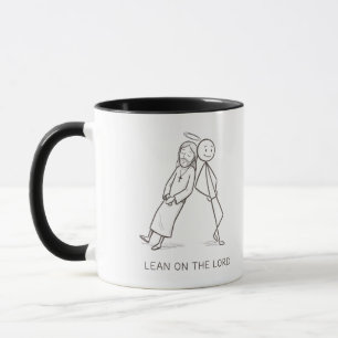 Taza de café cristiana con figura de palo apoyada 