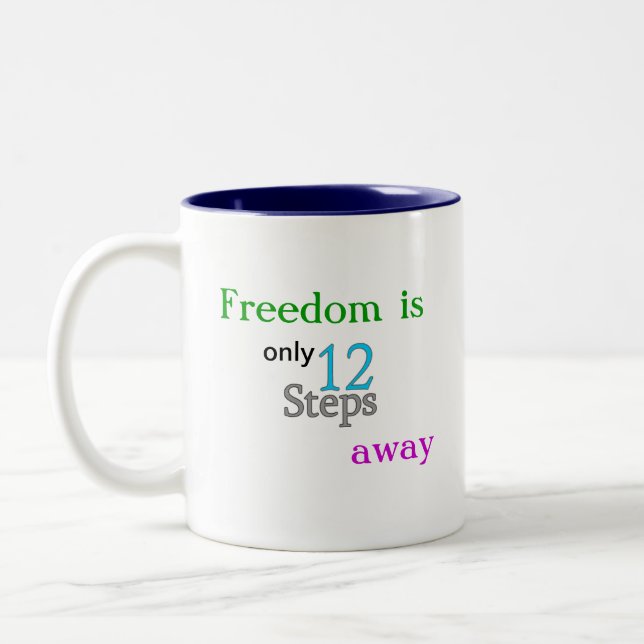 Taza de café de la libertad del paso del AA 12 (Izquierda)