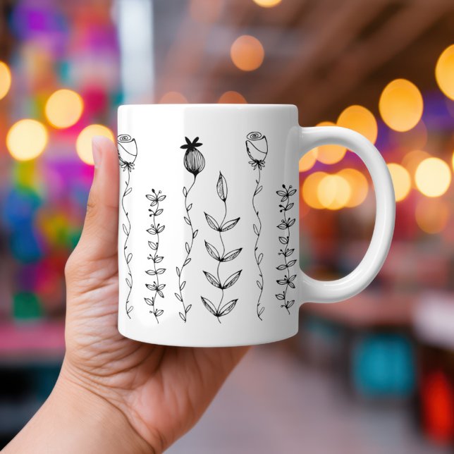 Taza De Café Elegante Ilustracion floral Boho (A hand holds a Hand-drawn simple Boho florals on a white mug.  Atmospheric lights in the background.)