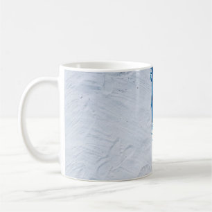 Taza De Café Escarcha floral azul y negra sobre arena blanca