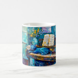 Taza De Café Gato está durmiendo en el piano