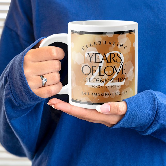 Taza De Café Gigante Elegante 22° Aniversario del Boda del Cobre (22nd wedding anniversary jumbo mug held by woman sporting a wedding ring and blue sweatshirt.)