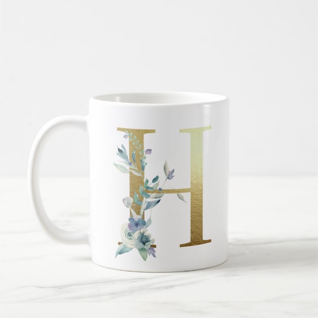 Taza De Café H dorado inicial con follaje floral azul (Izquierda)