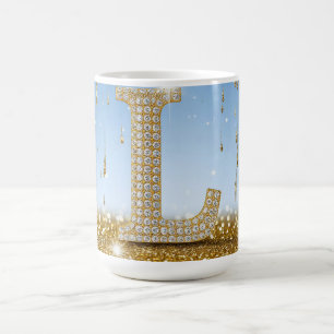 Taza De Café Letra L sobre fondo de purpurina dorada con destel