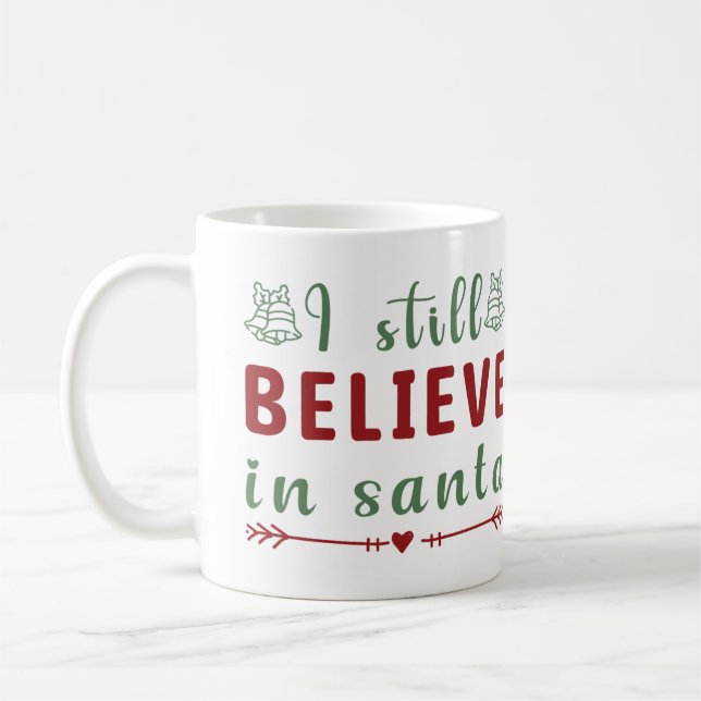 Taza De Café Todavía creo en Santa Navidades (Izquierda)