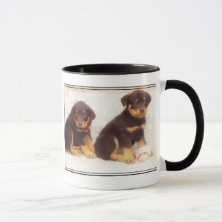 Taza de los perritos de Rottweiler