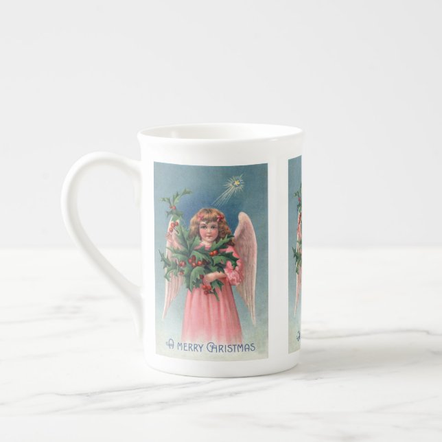 Taza de té rosada del ángel del navidad del (Izquierda)