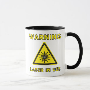 Taza del símbolo amonestador de laser