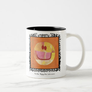 taza feliz de la cara del klee de Paul