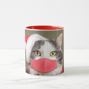 Taza Feliz gato navideño en Santa Hat y la máscara faci