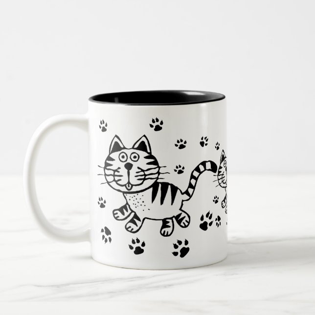 Taza linda de las impresiones del gato y de la (Izquierda)