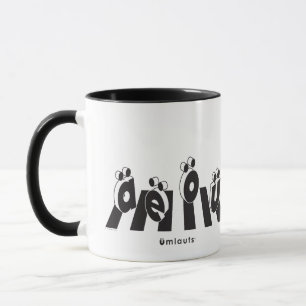 Taza “Los Umlauts™ Cruzando”