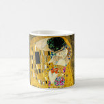 Taza Mágica Gustav Klimt - El Beso / El día de San Valentín<br><div class="desc">El Kiss (en alemán Der Kuss) es una pintura al óleo sobre lienzo con hojas de oro, plata y platino añadidas por el pintor simbolista austríaco Gustav Klimt. El cuadro representa a una pareja que se abrazan entre sí, con sus cuerpos entrelazados con bonitos y elaborados vestidos de un estilo...</div>