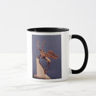 Taza Manija del florero bajo la forma de cabra montés
