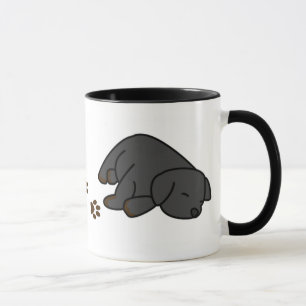 Taza negra soñolienta del perrito del laboratorio