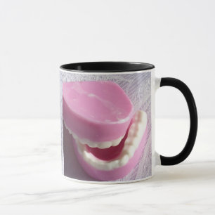 Taza noms del dentista de las dentaduras de los dientes