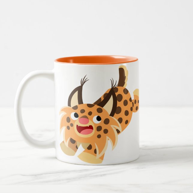 Taza traviesa linda del lince del dibujo animado (Izquierda)