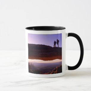 Taza Una pareja observa el amanecer desde la cima del A