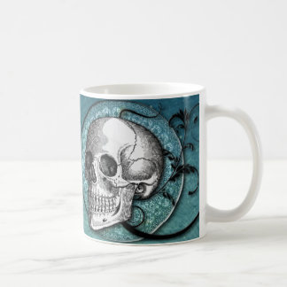 Taza verde azulada del cráneo y de café de los