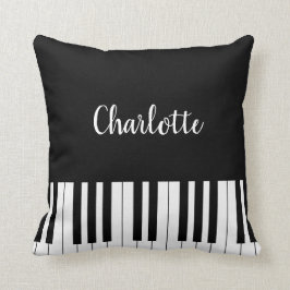Teclado de piano, almohada blanco y negro