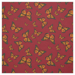 Tela Patrón mariposa monarca en fondo rojo oscuro