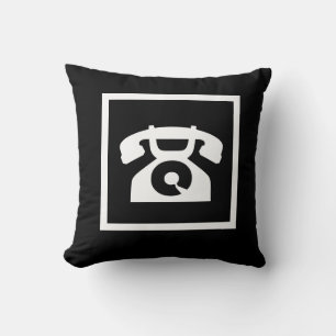teléfono blanco retro en almohada negra