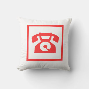 teléfono rojo retro sobre almohada blanca