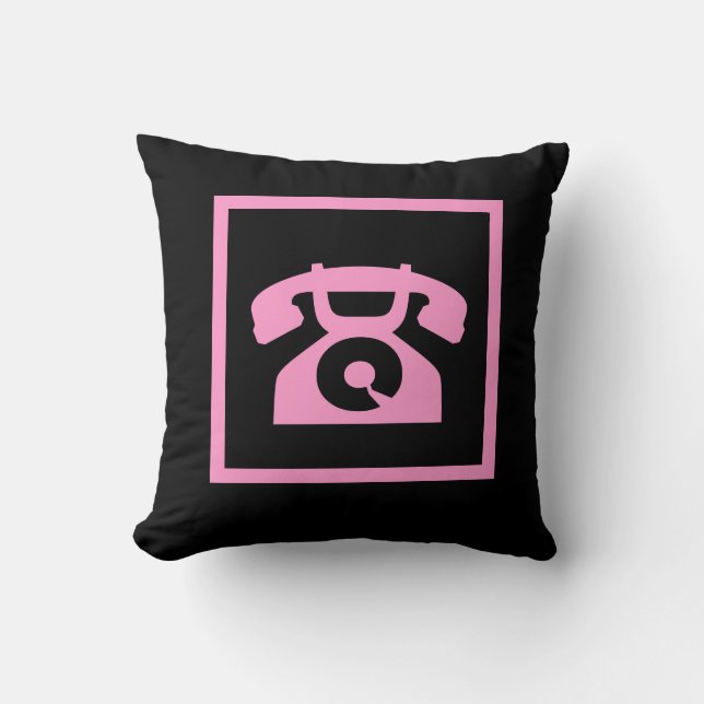 teléfono rosa retro sobre almohada negra (Anverso)