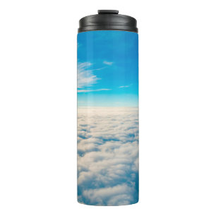 Termo Amanecer por encima de las nubes desde la ventana 