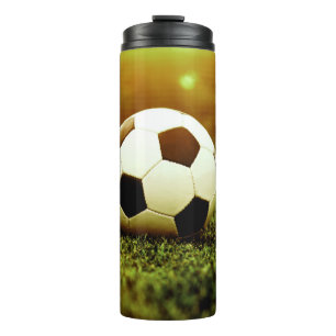 Termo Balón de fútbol en la hierba
