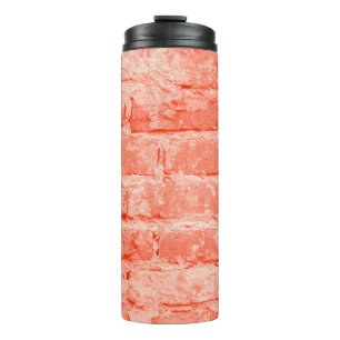 Termo Living Coral. Brick wall background. Closeup horiz
