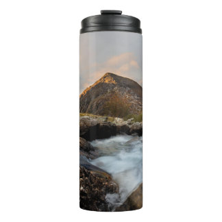 TERMO MONTAÑA MARRÓN CERCA DEL CUERPO DE AGUA BAJO EL CI