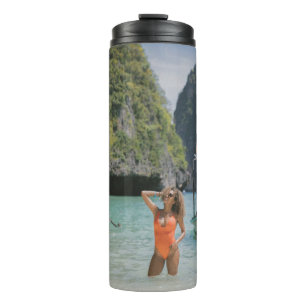 Termo Mujer en cuerpo de agua entre botes marrones