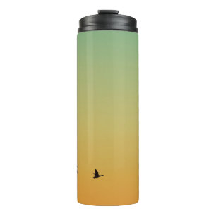 TERMO SILHOUETTE DE AVES VOLANDO DURANTE EL SOL