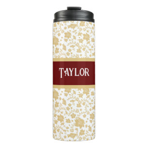 Termo Taza térmica floral dorada con fondo blanco