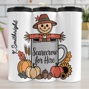 Termo Un espantapájaros por el alquiler en una taza