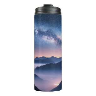 Termo Vía Láctea sobre montañas en niebla por la noche e