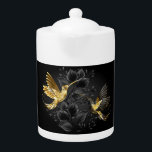 Tetera Colibrí negro y dorado<br><div class="desc">Colibríes con joyas negras y doradas sobre un fondo gris adornado con plantas. Aves de joyas. Ave dorada. Ave dorada.</div>