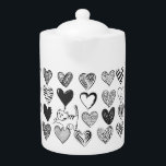 Tetera Patrón de gato y corazón negro y blanco<br><div class="desc">Gato juguetón colgando en un globo con forma de corazón rodeado de diferentes corazones con estampado en blanco y negro.</div>