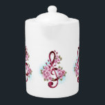 Tetera Tejidos musicales notas de colores con flores de S<br><div class="desc">El aroma rosa del trébol con delicadas y detalladas flores japonesas de cerezo rosadas en un fondo blanco pintado con pintura azul claro. Sakura rosa floreciente.</div>