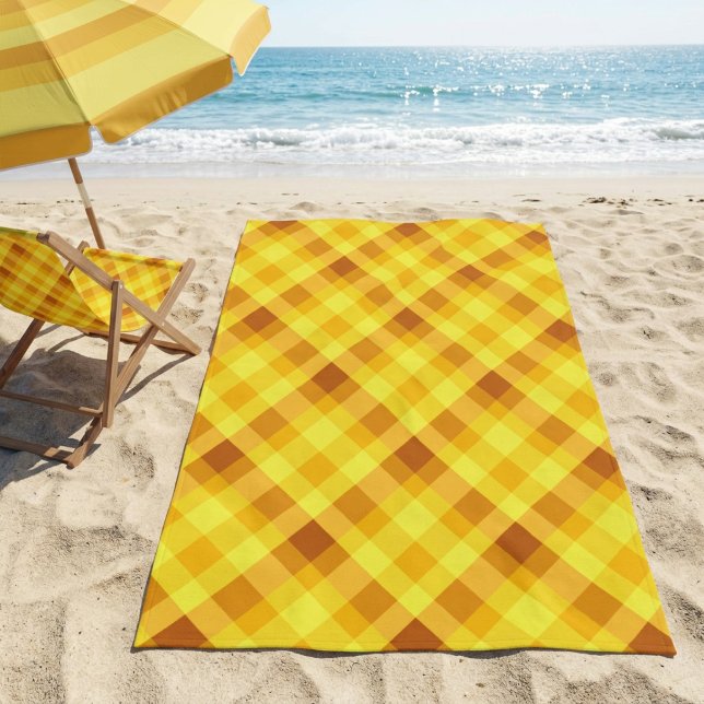 Toalla de Playa a Cuadros Amarillo Huevo Cute (Cute Egg Yolk Yellow Plaid Beach Towel on a sandy beach next a to chair and unbrella near an ocean.)