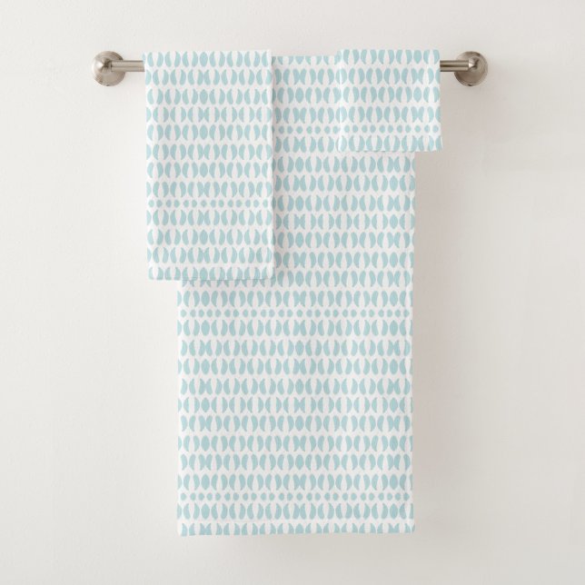 Towels with a light blue fish pattern hang neatly (Subido por el creador)