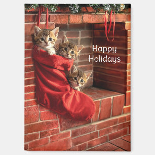 Tres gatitos en un imán de calcetín de Navidad