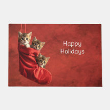 Tres gatitos en una Alfombra de Navidad