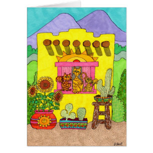 Tres gatos en una casa de Adobe amarillo