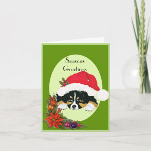 Tri perrito negro del navidad en una tarjeta de
