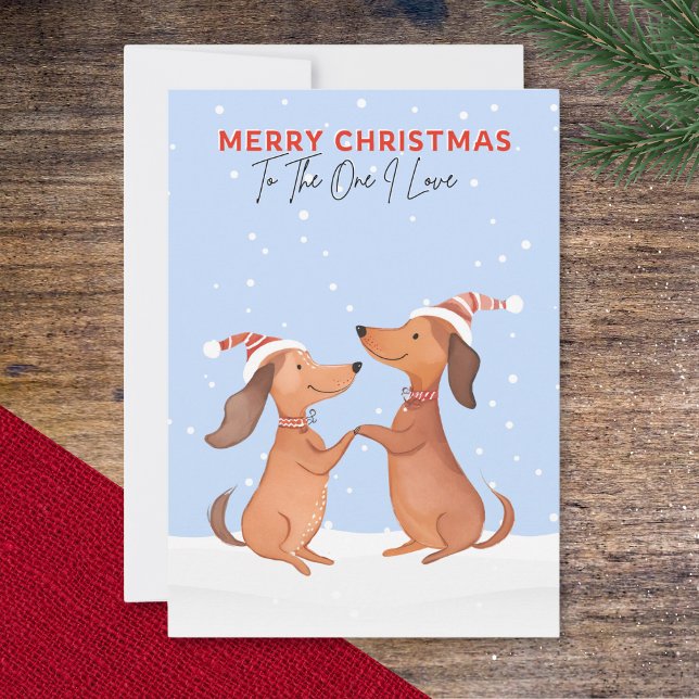 Un adorable Navidad Perritos Dachshund (A Christmas card with two cartoon dachshunds in the snow, 'Merry Christmas' and 'To The One I Love')