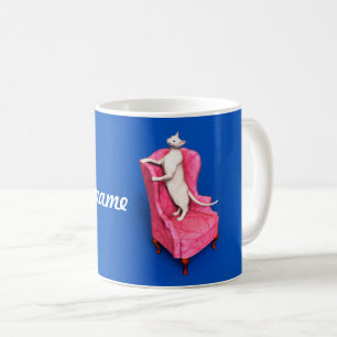 Un gato oriental sobre una taza de café en un sill