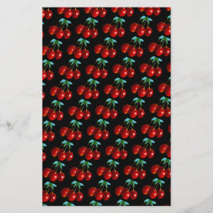 Un patrón de cerezas rojas sobre hojas de piedra e